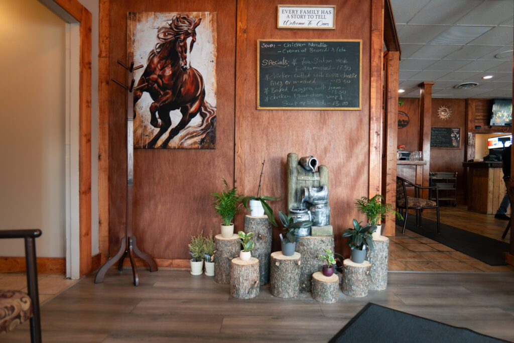 A festive event setup with elegant decorations at Blue Grill Restaurant in Olds, Alberta.
Chef Chathura showcasing his culinary expertise during a live cooking demonstration at Blue Grill Restaurant.