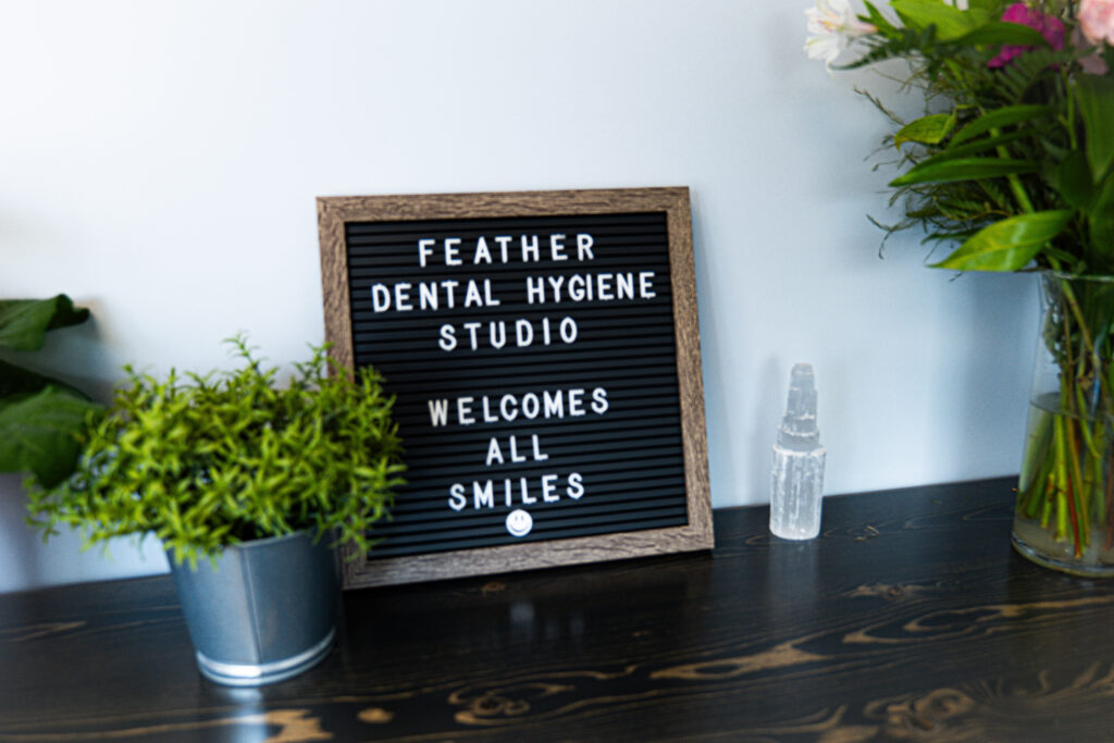 Signage showcasing the logo of Feather Dental Hygiene Studio